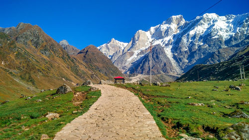 Scenic view of mountains against blue sky