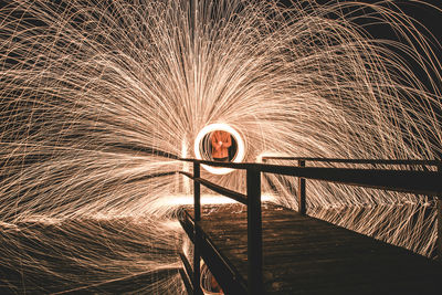 Blurred motion of man standing at night
