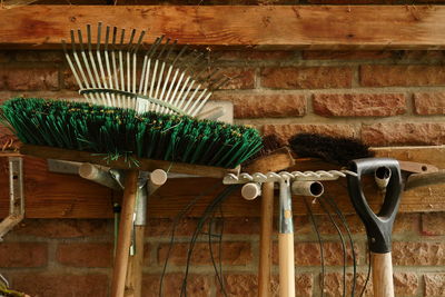 Gardening fork and broom against wall