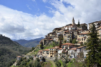 Buildings in town against sky