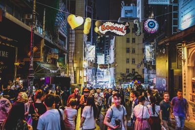 Crowd in illuminated city at night