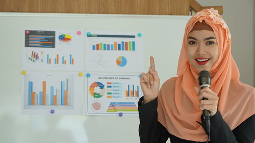 Portrait of young woman working at office