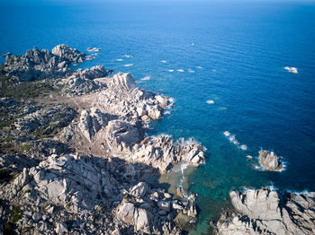 High angle view of rocks on sea shore against sky