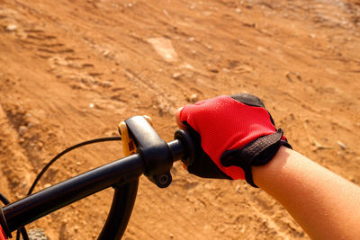 Close-up of man riding bicycle on road