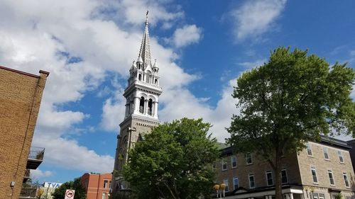 Low angle view of building against cloudy sky