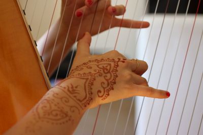 High angle view of woman hand with tattoo