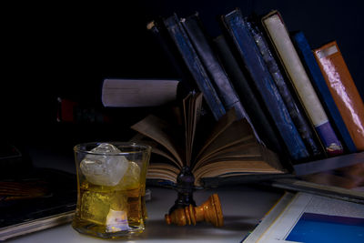 Close-up of glass of books on table
