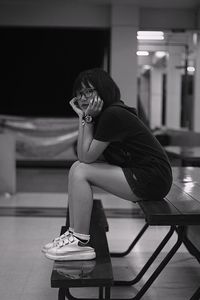 Young woman sitting on floor