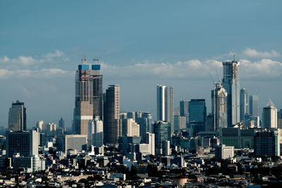 Modern buildings in city against sky