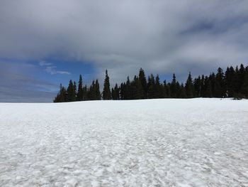 Scenic view of snow covered land against sky