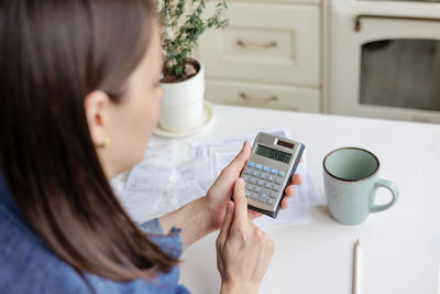 Businesswoman using calculator