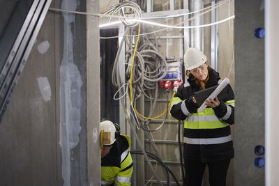 Female engineer using digital tablet at building site