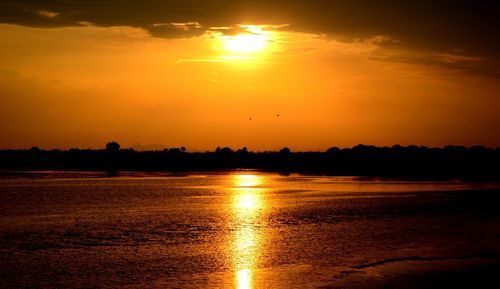 Scenic view of sea against orange sky