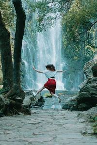 Rear view of woman standing in lake