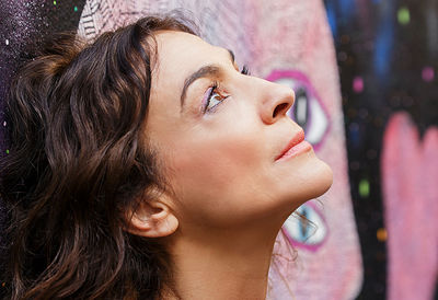 Close-up portrait of young woman looking away