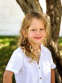 Portrait of smiling young woman standing outdoors