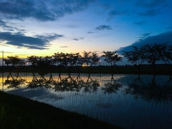 Scenic view of lake against sky during sunset