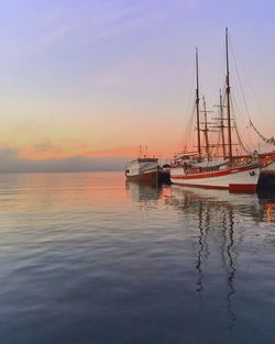 Sailboat in sea at sunset