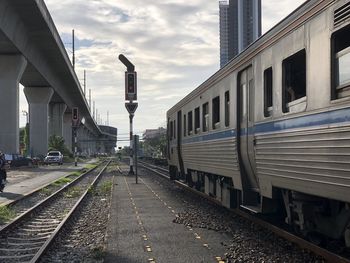 Train at railroad tracks against sky