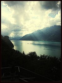 Scenic view of lake against cloudy sky
