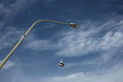 Sneakers hanging from the lamppost of the light