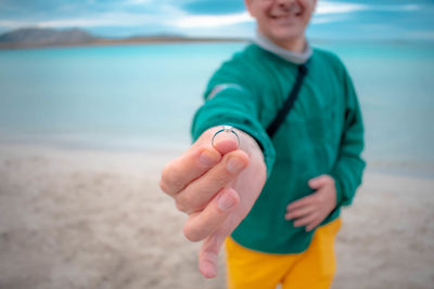 Midsection of man standing on beach