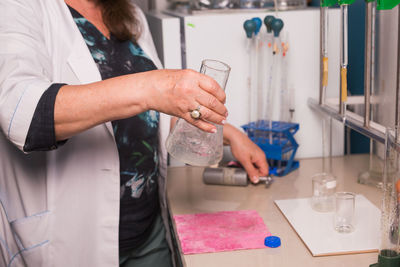 Midsection of woman working on table