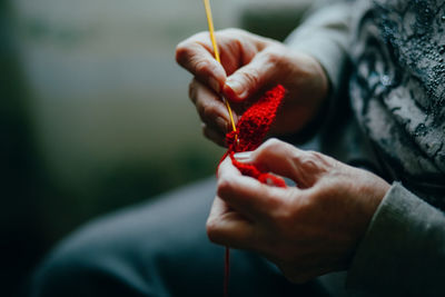 Midsection of woman weaving