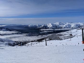 Scenic view of snow covered mountains against sky