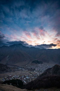 Scenic view of snowcapped mountains against sky during sunset