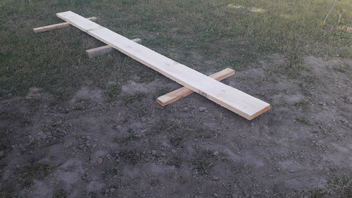 High angle view of empty bench on field