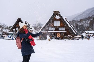 Woman standing on snow covered mountain