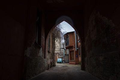 Empty alley amidst buildings in tunnel