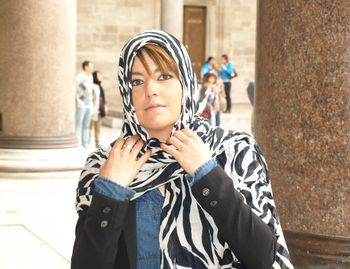 Portrait of woman standing on street,ready to enter in a mosque