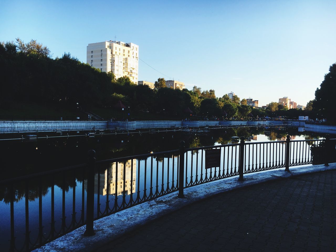 architecture, built structure, tree, building exterior, water, reflection, clear sky, calm, waterfront, day, outdoors, canal, tranquility, scenics, tranquil scene, standing water, long, no people, bridge