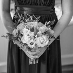 Midsection of woman holding flower bouquet