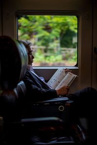 Man sitting on train window