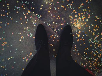 Low section of man standing on tiled floor