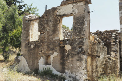 Old damaged building against sky