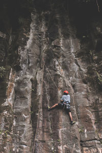 Rear view of person skiing on rock