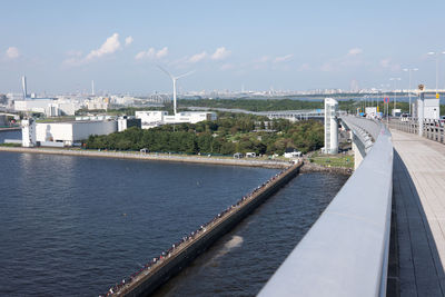 Bridge over sea in city against sky