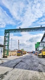 Cranes at construction site against sky