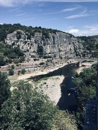 Scenic view of rocks and trees against sky