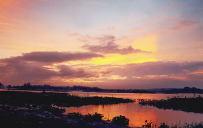 Scenic view of lake against sky during sunset