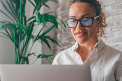 Smiling businesswoman using laptop