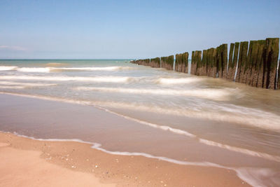 Scenic view of beach against clear sky