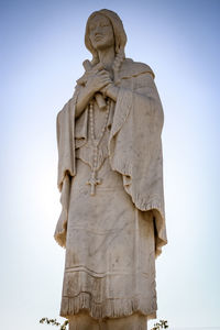 Low angle view of statue against sky. chatholic saint