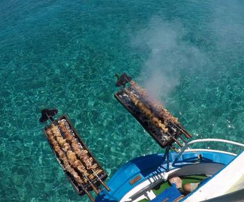 High angle view of barbecue meat on boat in sea