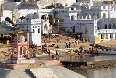 Pilgrims at pushkar lake on sunny day