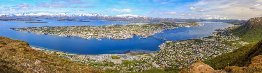 Panoramic view of sea and cityscape against sky